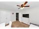 Bedroom with ceiling fan, closet, tv and neutral walls with a heart decoration at 1103 Coleman Sw St, Atlanta, GA 30310