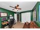 Well lit bedroom with ceiling fan, futon, desk, and neutral carpeting at 1103 Coleman Sw St, Atlanta, GA 30310
