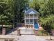 Charming two-story home with a double balcony and landscaped yard behind a black metal fence at 1103 Coleman Sw St, Atlanta, GA 30310