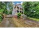 Two-story home featuring double balconies, a side chimney, and lush landscaping at 1103 Coleman Sw St, Atlanta, GA 30310