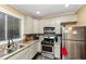 A modern kitchen with stainless steel appliances, granite counters, and tile backsplash at 1103 Coleman Sw St, Atlanta, GA 30310