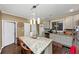 A view of a kitchen with stainless appliances, tile backsplash and a granite island at 1103 Coleman Sw St, Atlanta, GA 30310