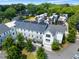 An aerial view of townhomes with solar panels surrounded by mature trees shows the neighborhood at 204 Wilbur Se Ave, Atlanta, GA 30316