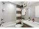 Stylish bathroom features herringbone tile, shower with tub, modern vanity, and elegant decor at 204 Wilbur Se Ave, Atlanta, GA 30316