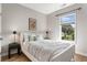 Stylish bedroom with a comfortable bed, side tables, and a window overlooking a green view at 204 Wilbur Se Ave, Atlanta, GA 30316