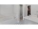 Elegant bathroom with a soaking tub, patterned tile flooring, and a view into the walk-in closet at 323 Hayden Circle Cir, Woodstock, GA 30189