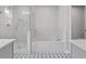 Well-appointed bathroom showcasing a separate glass shower, a soaking tub, and patterned tile flooring at 323 Hayden Circle Cir, Woodstock, GA 30189
