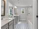 Modern bathroom features double vanity, patterned tile floor, and glass-enclosed shower at 323 Hayden Circle Cir, Woodstock, GA 30189