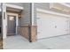 Close up of a townhome's garage and front door with brick and gray color palette at 323 Hayden Circle Cir, Woodstock, GA 30189