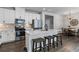 Bright kitchen featuring white cabinets, stainless steel appliances, and a counter with barstool seating at 323 Hayden Circle Cir, Woodstock, GA 30189