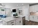 Open kitchen area featuring white cabinets, a center island, and views of the living room and fireplace at 323 Hayden Circle Cir, Woodstock, GA 30189