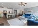 Open-concept living room featuring a kitchen with an island and a comfortable seating area with a blue sofa at 323 Hayden Circle Cir, Woodstock, GA 30189