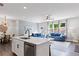 Bright open concept featuring a kitchen with white island that flows into the dining and living area at 323 Hayden Circle Cir, Woodstock, GA 30189