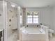 Bathroom features a shower, tub, and window at 4255 Brandy Ann Dr, Acworth, GA 30101