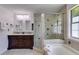 Updated bathroom with a double sink vanity, walk-in shower, and soaking tub at 4255 Brandy Ann Dr, Acworth, GA 30101