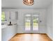 Bright dining area with hardwood floors, double doors to a deck, and a decorative chandelier at 4255 Brandy Ann Dr, Acworth, GA 30101