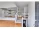 Inviting foyer with hardwood floors, leading to an open-concept kitchen with white cabinets and a breakfast bar at 4255 Brandy Ann Dr, Acworth, GA 30101