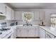 Updated kitchen featuring white cabinets, stainless steel sink, and a view of the backyard at 4255 Brandy Ann Dr, Acworth, GA 30101