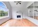 Bright living room featuring hardwood floors, a fireplace, and an open view to the kitchen at 4255 Brandy Ann Dr, Acworth, GA 30101