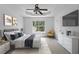 Staged main bedroom featuring neutral carpet, a ceiling fan, and decorative furniture at 4255 Brandy Ann Dr, Acworth, GA 30101