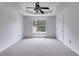 Spacious main bedroom with neutral carpet and a large window for natural light at 4255 Brandy Ann Dr, Acworth, GA 30101