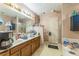 Bathroom featuring dual sinks, large mirrors, and a shower at 4945 Penscot Way, Stone Mountain, GA 30088