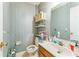 Powder room featuring sink, toilet, open shelving, and striped wallpaper at 4945 Penscot Way, Stone Mountain, GA 30088