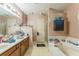 Large bathroom with dual sinks, soaking tub, walk-in shower and storage at 4945 Penscot Way, Stone Mountain, GA 30088