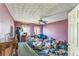 Cluttered bedroom with textured ceiling, ceiling fan, and natural light from two windows at 4945 Penscot Way, Stone Mountain, GA 30088