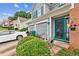 Welcoming front entrance with a teal door, and a two-car garage, enhancing curb appeal at 4945 Penscot Way, Stone Mountain, GA 30088