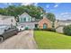 Charming home featuring a landscaped yard, attached two-car garage, and welcoming front entrance at 4945 Penscot Way, Stone Mountain, GA 30088