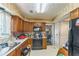 Kitchen with wood cabinets and black appliances at 4945 Penscot Way, Stone Mountain, GA 30088