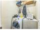 The laundry area has a washer, dryer, and wire shelf with clothing at 4945 Penscot Way, Stone Mountain, GA 30088