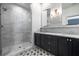 Modern bathroom with a glass enclosed shower and dual vanities at 77 Krog Ne St, Atlanta, GA 30307
