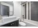 Bathroom features unique black-and-white tile work, a shower and tub combo, and a modern sink at 77 Krog Ne St, Atlanta, GA 30307
