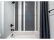 Modern bathroom featuring a black and white tiled wall, black fixtures, and a shower-tub combo at 77 Krog Ne St, Atlanta, GA 30307