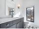 Bathroom featuring a marble countertop, black and white floors, and a large window at 77 Krog Ne St, Atlanta, GA 30307