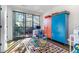 Bedroom area with a colorful rug, workspace, and floor-to-ceiling sliding glass door at 77 Krog Ne St, Atlanta, GA 30307