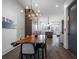 Chic dining area with chandelier and views into a modern kitchen at 77 Krog Ne St, Atlanta, GA 30307
