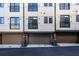 Modern townhouse exterior featuring attached garages and black-framed windows at 77 Krog Ne St, Atlanta, GA 30307