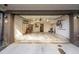 Open garage with concrete floor, overhead lighting and shelving at 77 Krog Ne St, Atlanta, GA 30307