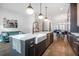 Open concept kitchen with island seating flows seamlessly to the dining and living areas at 77 Krog Ne St, Atlanta, GA 30307