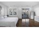 Bright main bedroom with hardwood floors and a private balcony at 77 Krog Ne St, Atlanta, GA 30307