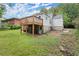 Lawn view of back of house featuring a deck, stone foundation, and access door at 1098 Cascade Sw Cir, Atlanta, GA 30311