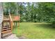 Picturesque backyard featuring a lush green lawn, wooden deck, and mature trees at 1098 Cascade Sw Cir, Atlanta, GA 30311