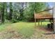 Spacious backyard with a wooden deck, green lawn, mature trees, and ample shade at 1098 Cascade Sw Cir, Atlanta, GA 30311