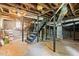 Unfinished basement with concrete floor, exposed beams, ductwork, and stairs leading to the upper level at 1098 Cascade Sw Cir, Atlanta, GA 30311
