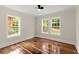 Bedroom with hardwood floors and bright sunlit windows overlooking the neighborhood at 1098 Cascade Sw Cir, Atlanta, GA 30311
