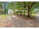 Long driveway leading to a home with a well-maintained yard and mature trees at 1098 Cascade Sw Cir, Atlanta, GA 30311