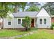 Charming home with gray siding, red front door, well-manicured lawn, and stone walkway at 1098 Cascade Sw Cir, Atlanta, GA 30311